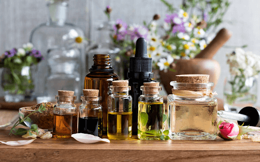 colorful and soothing essential oil in bottles with floral background