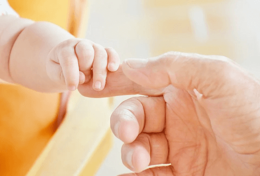 mother holding baby's hand How to Make Your Own Baby Wipes for Sensitive Skin